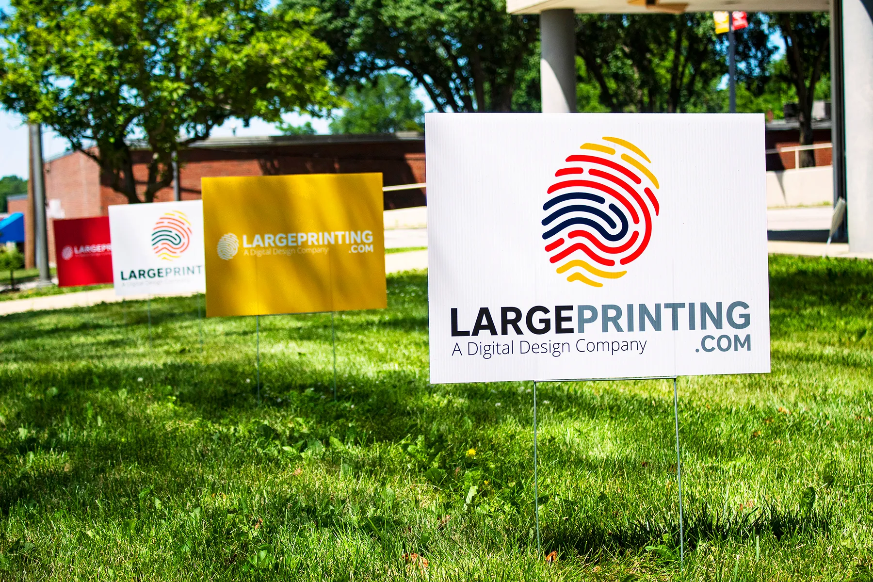 white Coro-last yard sign with finger print logo in red blue and yellow